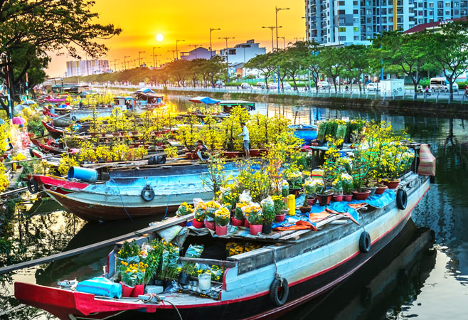 Flower boats full of cay mai Tet are sold during Vietnam Lunar New Year